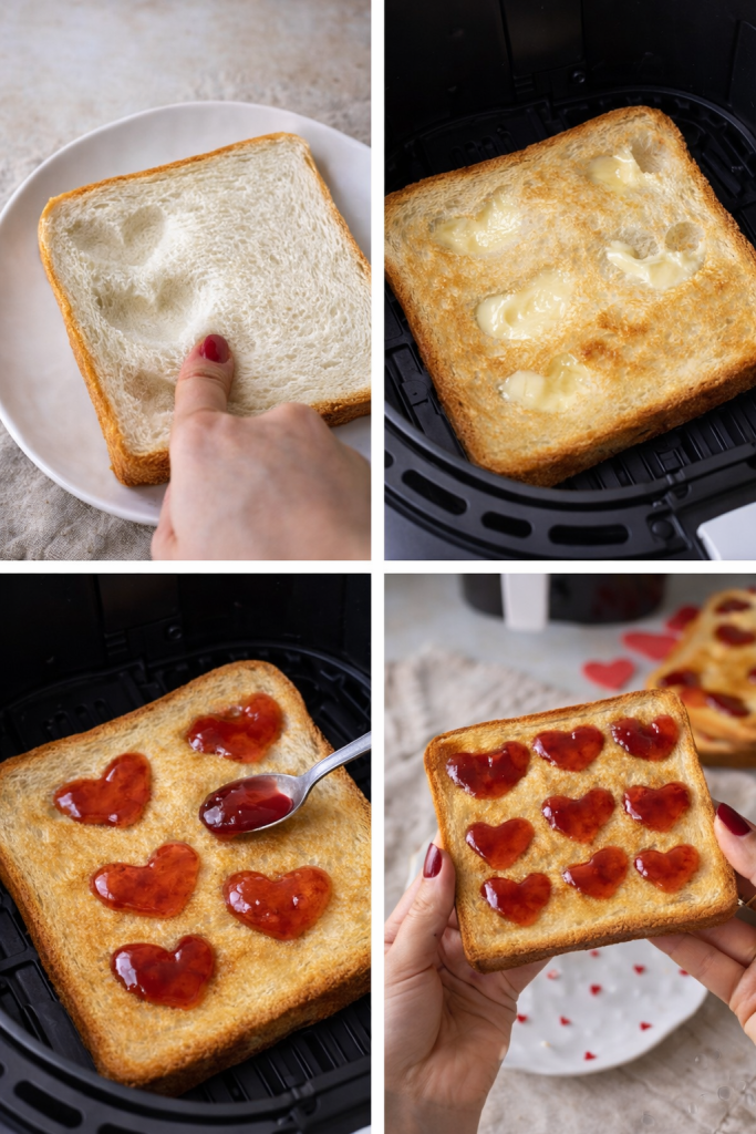 Cuori disegnati sul pane con le dita prima della cottura in friggitrice ad aria.
Pane tostato con burro in friggitrice ad aria durante la preparazione del toast romantico.
marmellata inserita nelle forme a cuore sul pane tostato.
Toast con cuori di marmellata pronto per San valentino